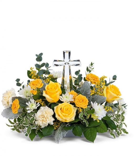 Sympathy funeral flower arrangement with yellow carnations, white mums, and a crystal cross