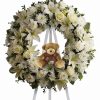 Baby boy funeral flowers teddy bear standing spray with white lilies and pearl roses