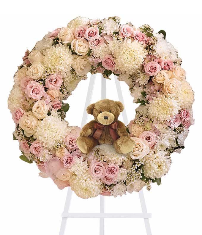 Baby girl funeral wreath spray with pink hydrangeas cream roses pale pink spray roses chrysanthemums waxflower teddy bear and easel stand