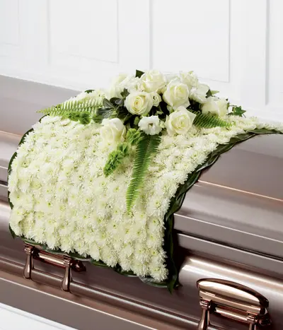 Blanket of Blooms white casket flower blanket with white chrysanthemums, roses, lisianthus, Bells of Ireland and greenery