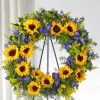 Bright Rays Wreath with yellow sunflowers blue delphinium solidago English ivy springerii fern and wire easel