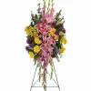 Fondly Remembered funeral standing spray with pink stargazer lilies yellow daisies gladioli carnations and larkspur