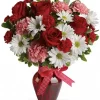 Hugs and Kisses Rose Bouquet with red roses, pale pink carnations, ruby mini carnations, white daisy mums, decorative bow and dark-red glass vase