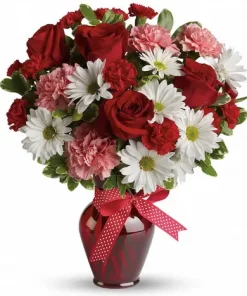 Hugs and Kisses Rose Bouquet with red roses, pale pink carnations, ruby mini carnations, white daisy mums, decorative bow and dark-red glass vase