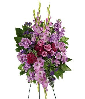 Lavender sympathy standing spray with purple roses alstroemeria gladiolus mums and statice