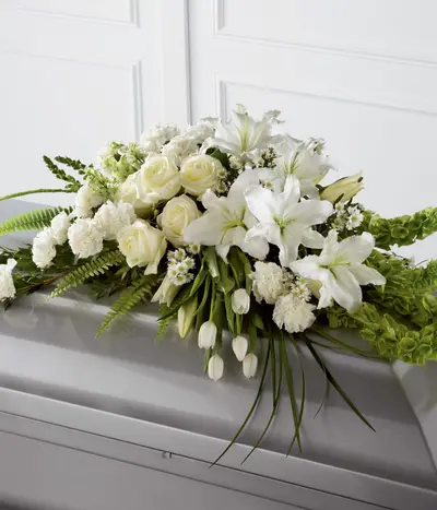 Loving Light Casket Spray with white tulips roses lilies carnations and snapdragons