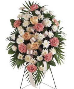 Pastel sympathy standing spray with carnations chrysanthemums and roses