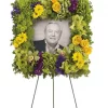 Square photo funeral wreath spray with green cymbidium orchids hydrangea Fuji mums carnations yellow roses daisies and easel stand
