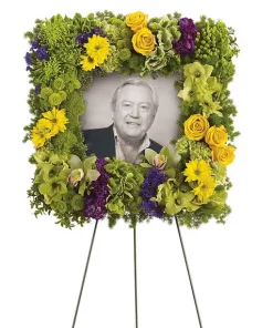 Square photo funeral wreath spray with green cymbidium orchids hydrangea Fuji mums carnations yellow roses daisies and easel stand