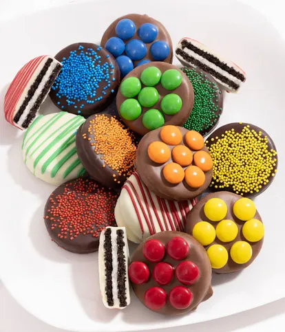 Turn a good day into a great day by sending someone special our Rainbow Belgian Chocolate Covered Oreo® Cookies! Dowsed in rich, creamy Belgian chocolate and topped off with vibrant sprinkles, there's no way you can go wrong with this unique gift! OREO® is a registered trademark of Mondelez International Group. Includes: • 12 OREO® Cookies • Hand-Dipped in Milk, Dark & White Belgian Chocolate • Decorated with vibrant sprinkles Rainbow Belgian Chocolate Covered OREO Cookies hand dipped in milk, dark, and white Belgian chocolate with vibrant sprinkles in an elegant gift box