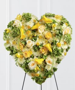 Golden heart funeral standing spray with yellow roses mini calla lilies freesia green hydrangea cream roses white chrysanthemums hypericum berries and easel stand