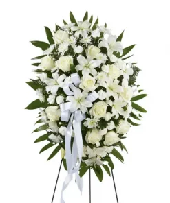 White funeral standing spray with lilies roses carnations and chrysanthemums