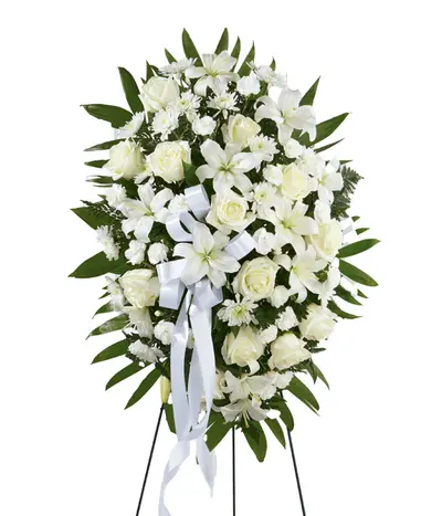 White funeral standing spray with lilies, roses, mini carnations and chrysanthemums