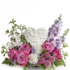 Wings of Serenity sympathy flowers with lavender roses, white carnations, purple blooms, and angel wing heart keepsake