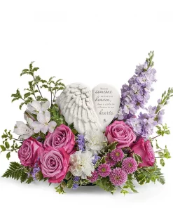 Wings of Serenity sympathy flowers with lavender roses, white carnations, purple blooms, and angel wing heart keepsake